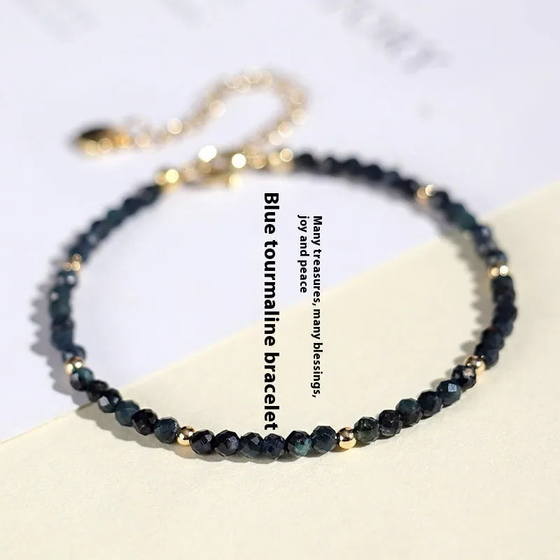 Women's blue tourmaline bracelet with 3mm beads and gold spacer beads
