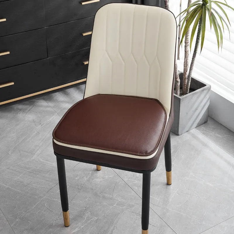 Horseshoe-shaped PU leather seat cushion in orange, shown on a chair.