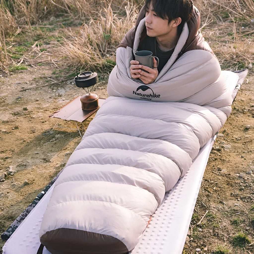 Goose down mummy-style sleeping bag in a storage bag, showing size and fill weight options.