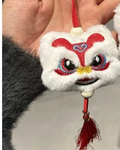 Blue and yellow handmade plush lion keychain ornaments with star stone decoration on white background.