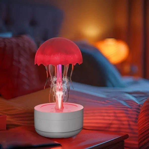 White jellyfish-shaped humidifier and essential oil diffuser with colourful LED lights on a desktop