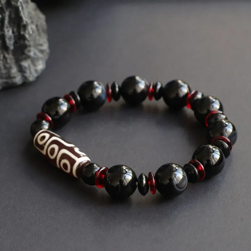 Hand-woven black agate and chalcedony dzi bead bracelet with geometric pattern