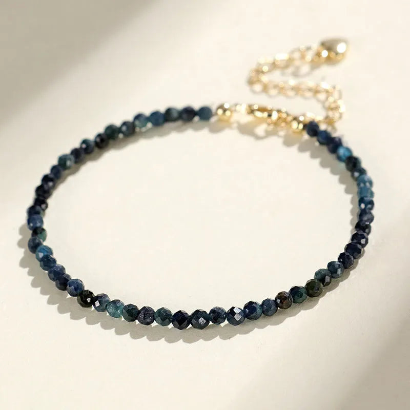 Women's blue tourmaline bracelet with 3mm beads and gold spacer beads
