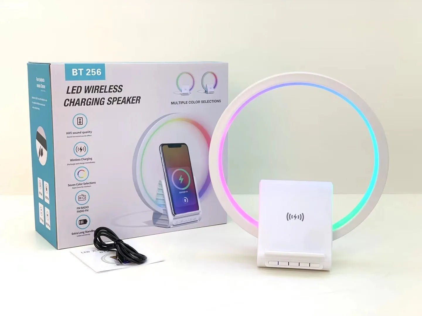 White smart Bluetooth speaker with wireless charging pad and ambient lighting measuring 225mm wide