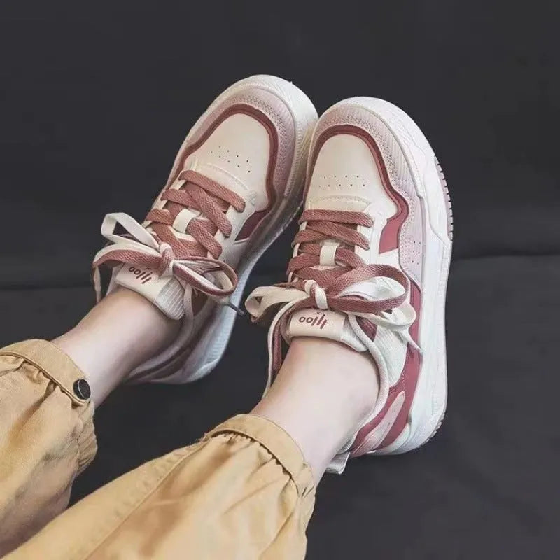 Beige and pink low-top platform sneakers with a rubber sole on a white background