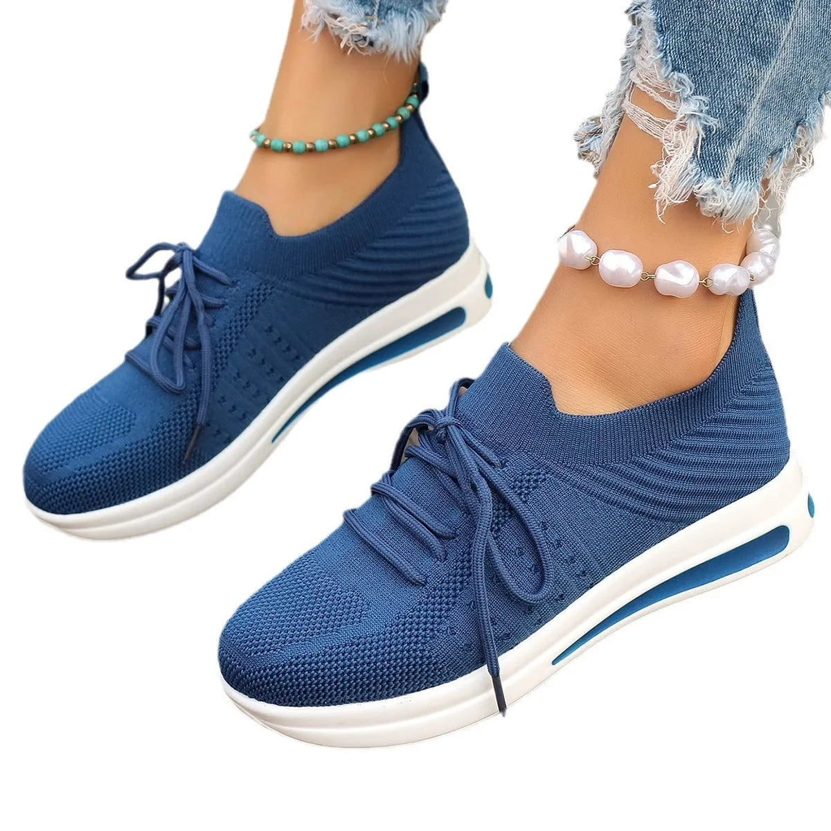 Women's low-top fly-knit sneakers in red colour with front lace-up closure and round-toe design