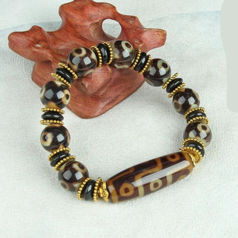 Agate Tibetan dzi bead bracelet with three-eye design and polished finish