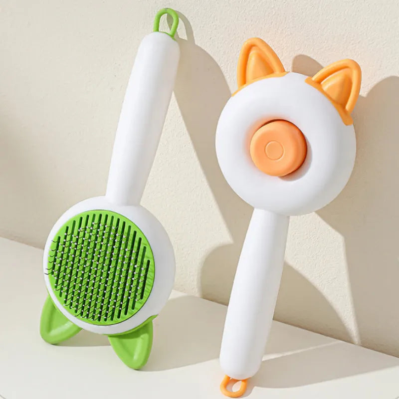 Greenish white cat grooming brush with stainless steel self-cleaning teeth and TPR massage tips
