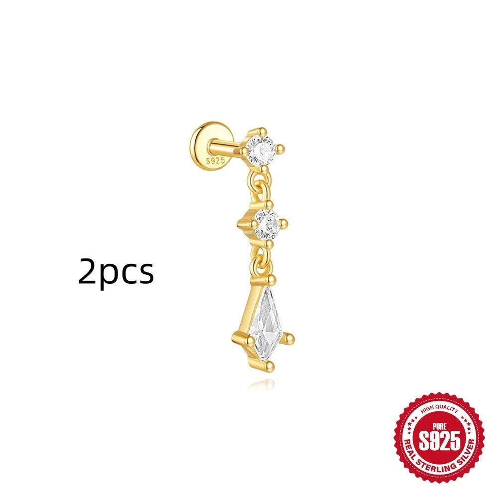 Geometric kite-shaped sterling silver earring with rhinestone head and gold chain tassel.