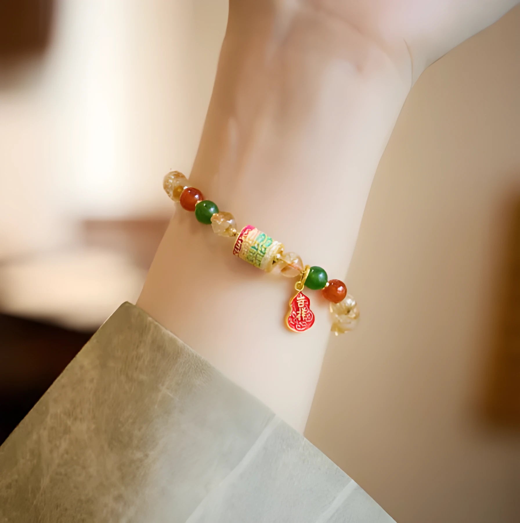 Close-up of a hand-woven citrine five sutra bracelet with 6mm geometric beads on a wrist.