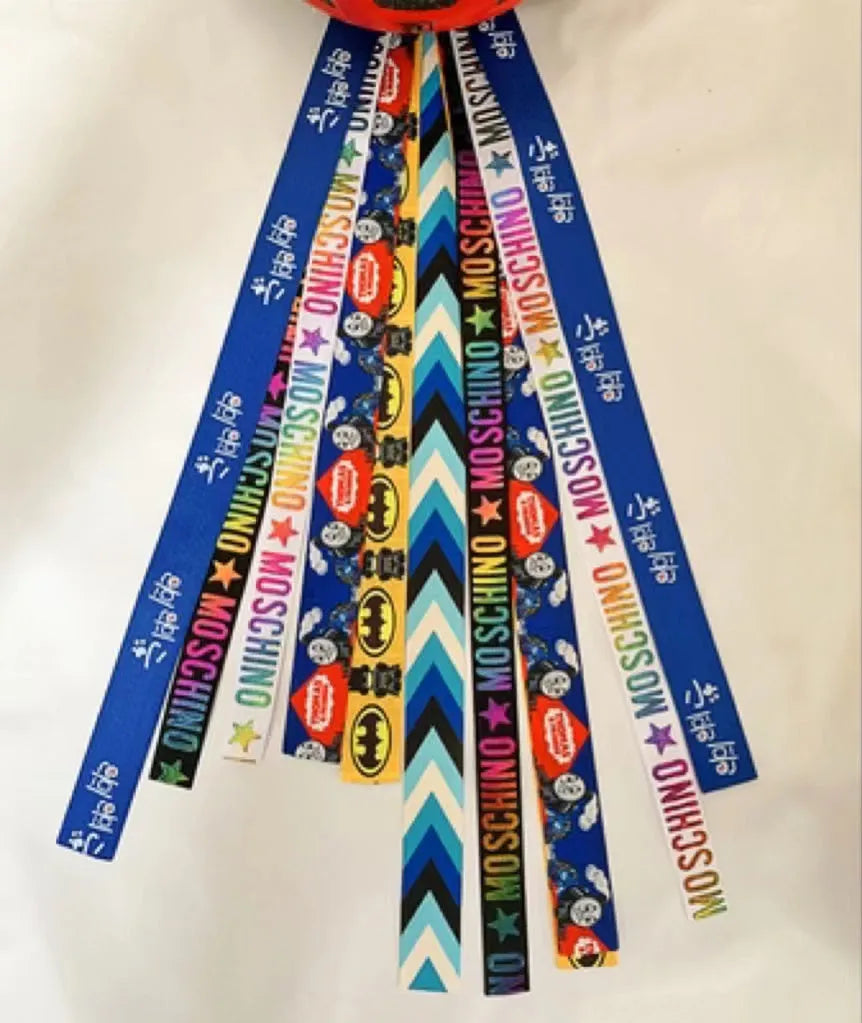 Close-up of a colourful decorative ribbon streamer attached to a child's helmet for roller skating or skiing.