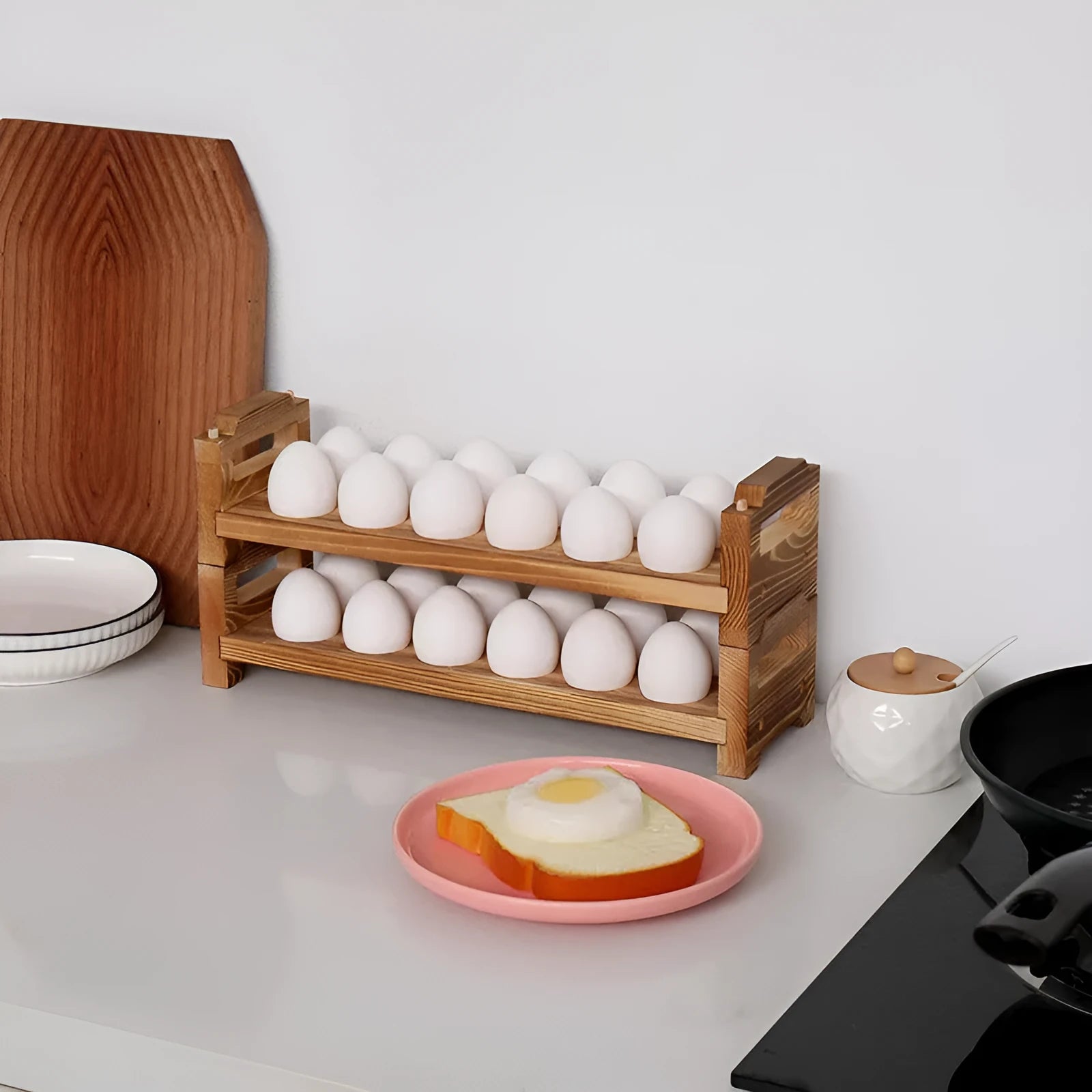 Solid wood egg storage rack in fire colour on a kitchen countertop