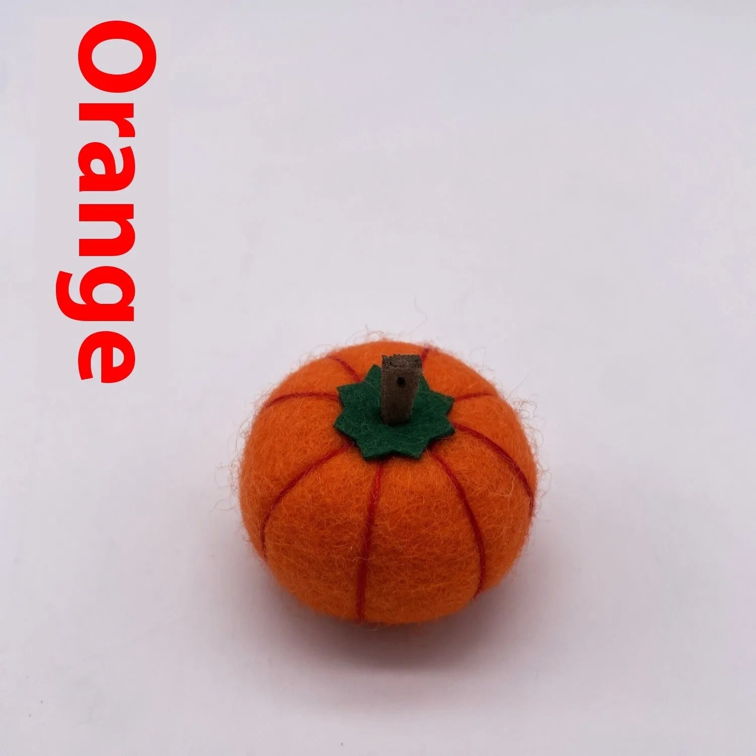 Wool felt pumpkin ornament in assorted colours for dollhouse decoration, approx. 5cm wide.