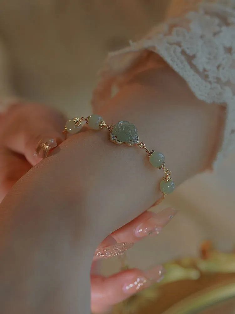 Hetian jade women's bracelet with rose flower design and 14K gold gilding details