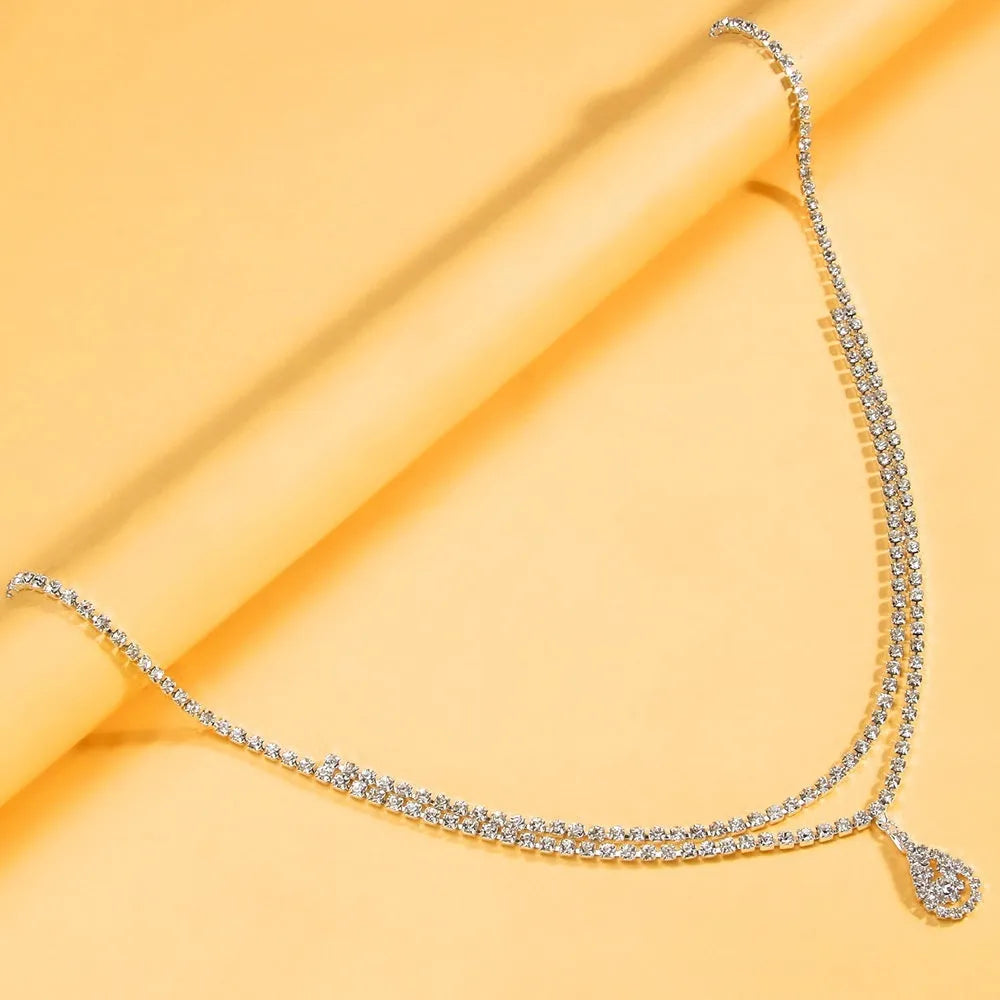 Gold waist chain with water drop rhinestone pendant and lobster buckle closure