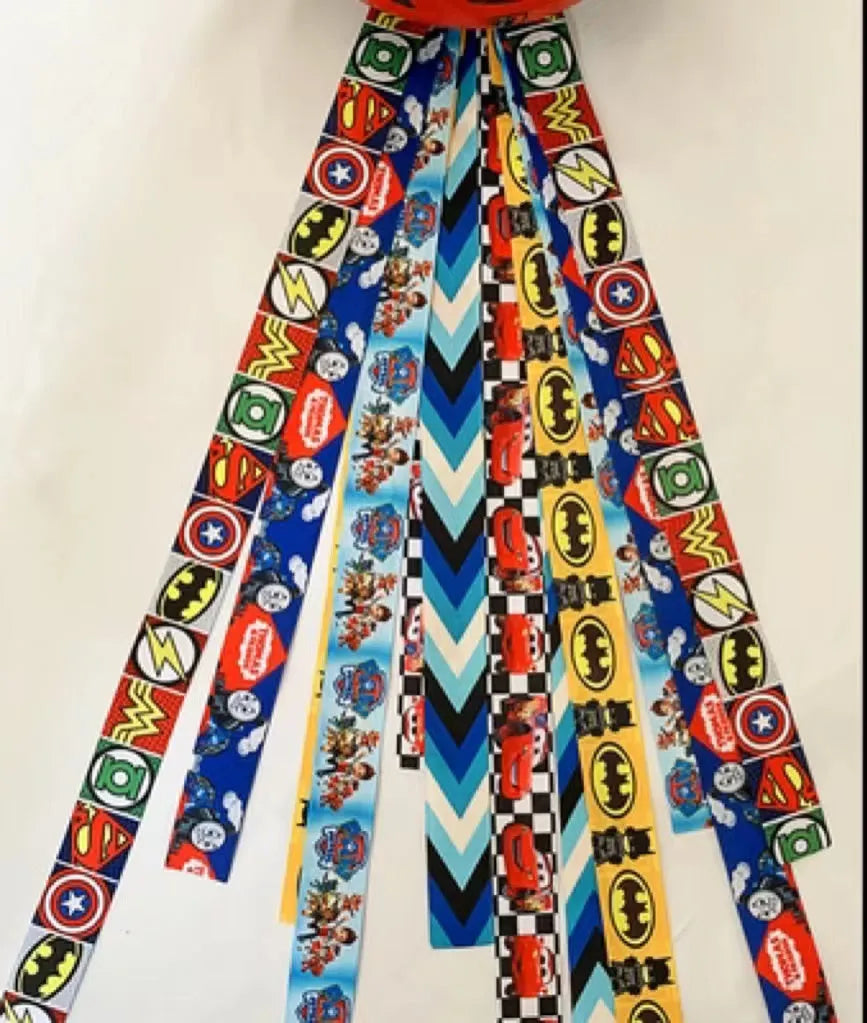 Close-up of a colourful decorative ribbon streamer attached to a child's helmet for roller skating or skiing.