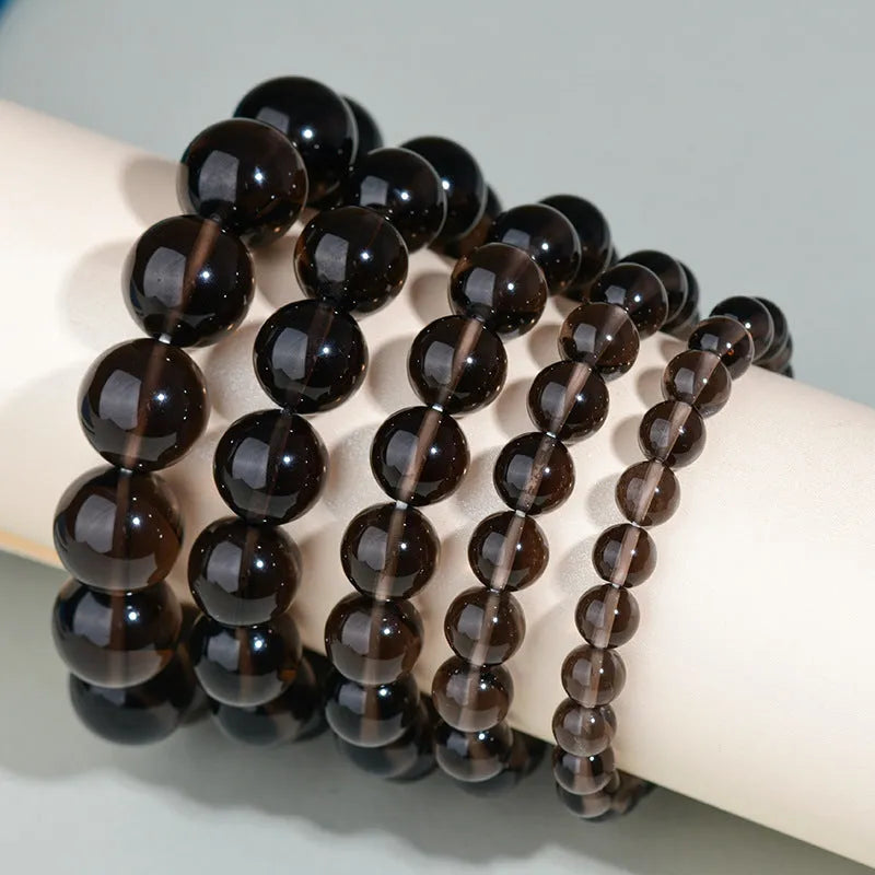 Hand-woven obsidian couple bracelet showing spherical black crystal beads in continuous strand construction
