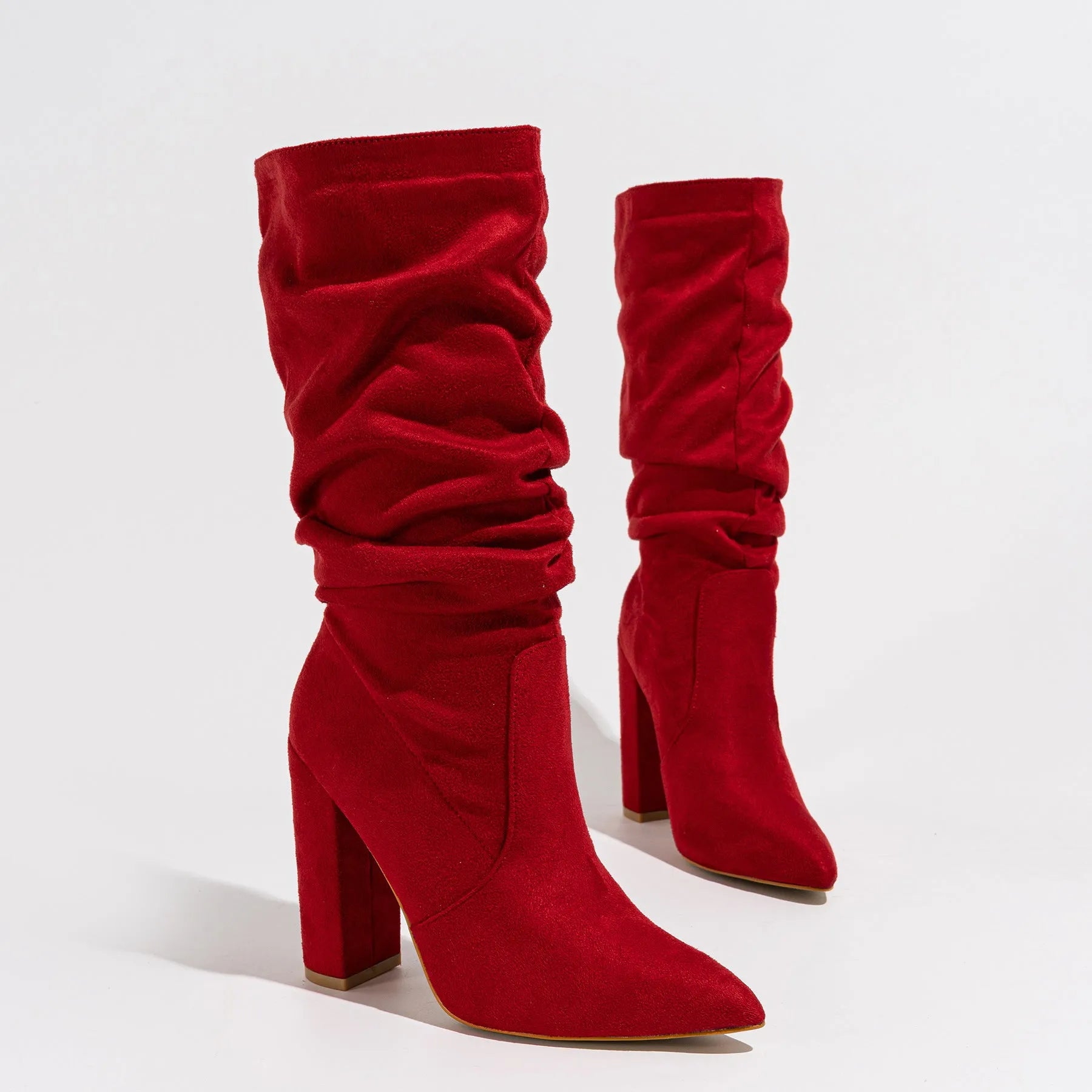 Women's black suede pointed-toe high heel boots with a chunky heel and middle calf length.