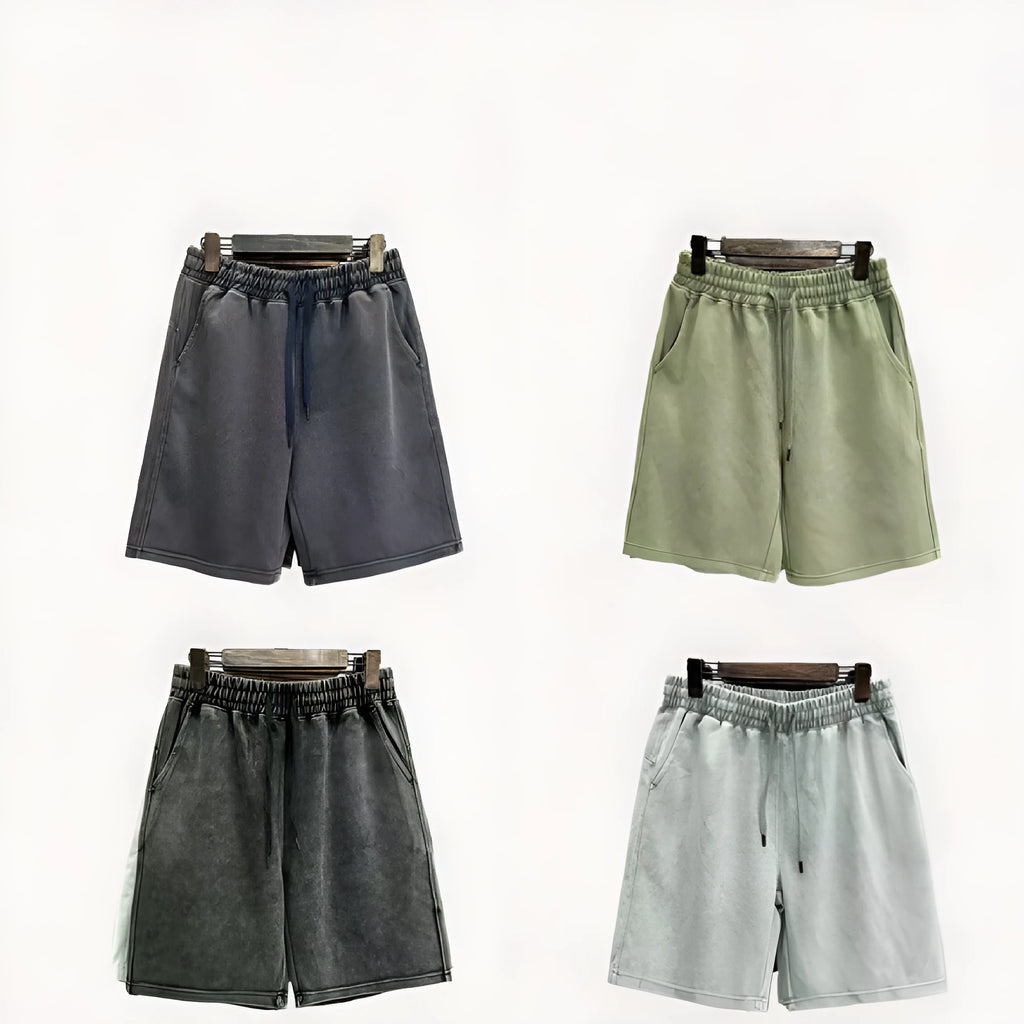 Men's charcoal black distressed denim shorts with straight leg and fifth pants length on a white background.