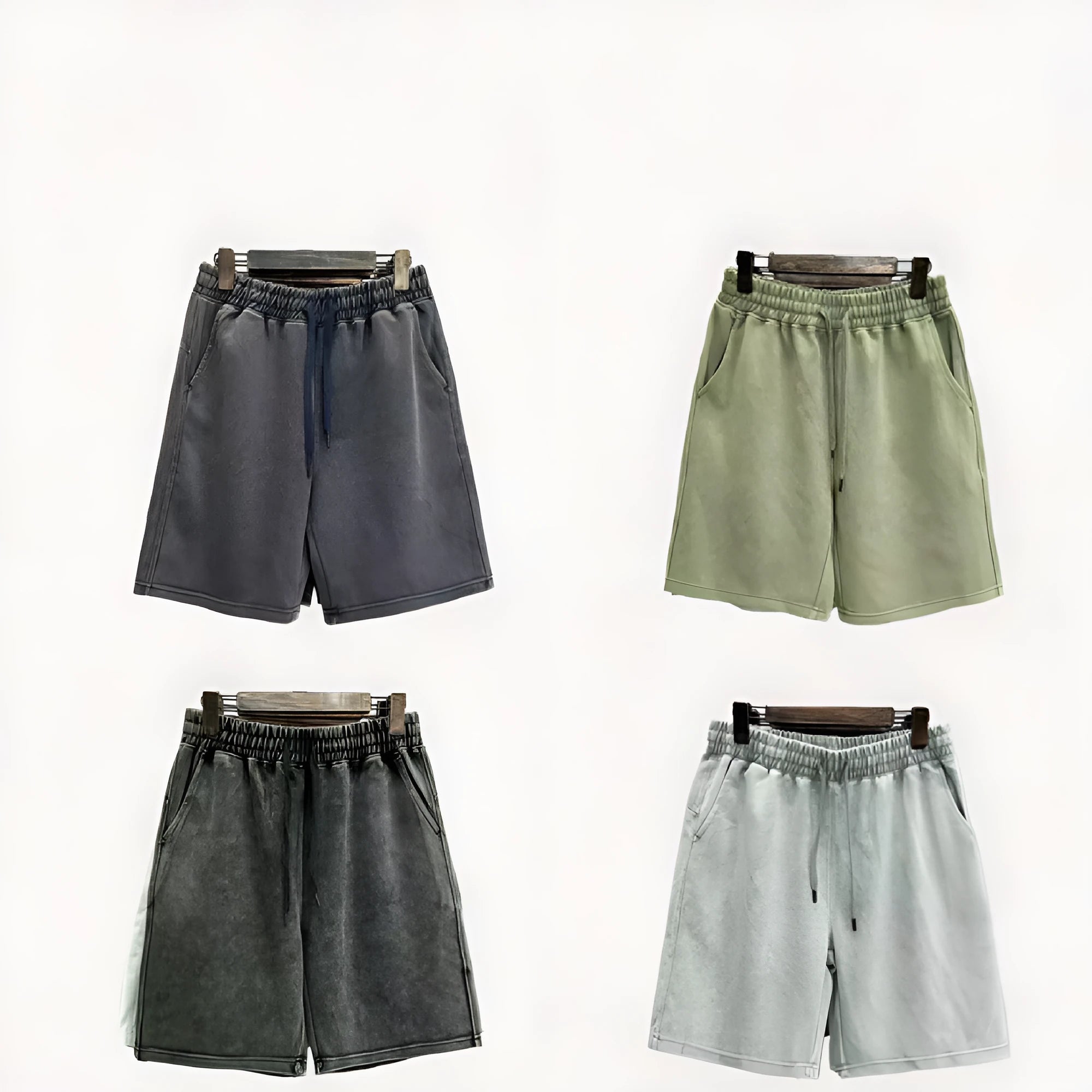 Men's charcoal black distressed denim shorts with straight leg and fifth pants length on a white background.