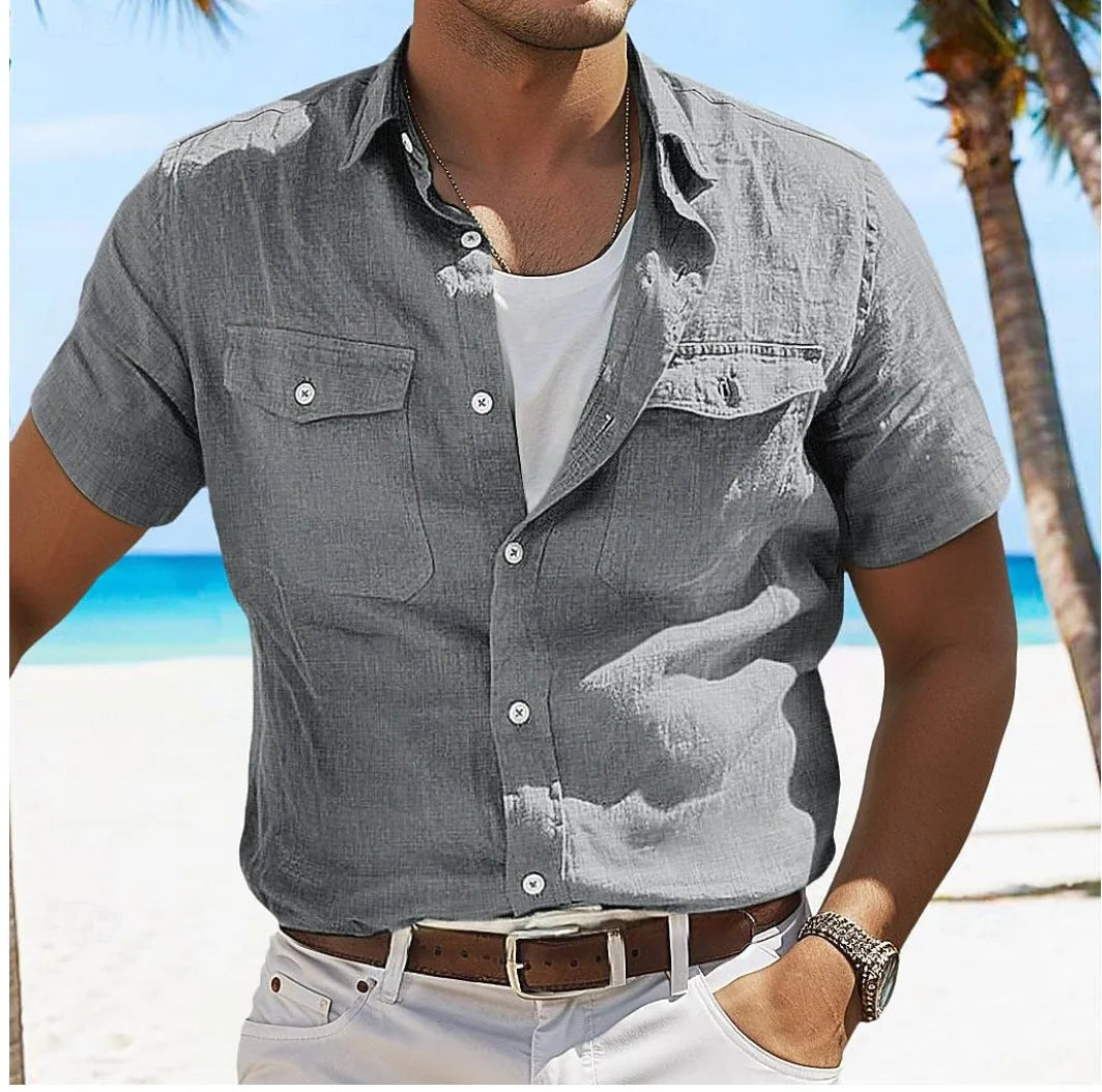 Man wearing a loose-fitting grey cotton cardigan-style shirt with long sleeves.
