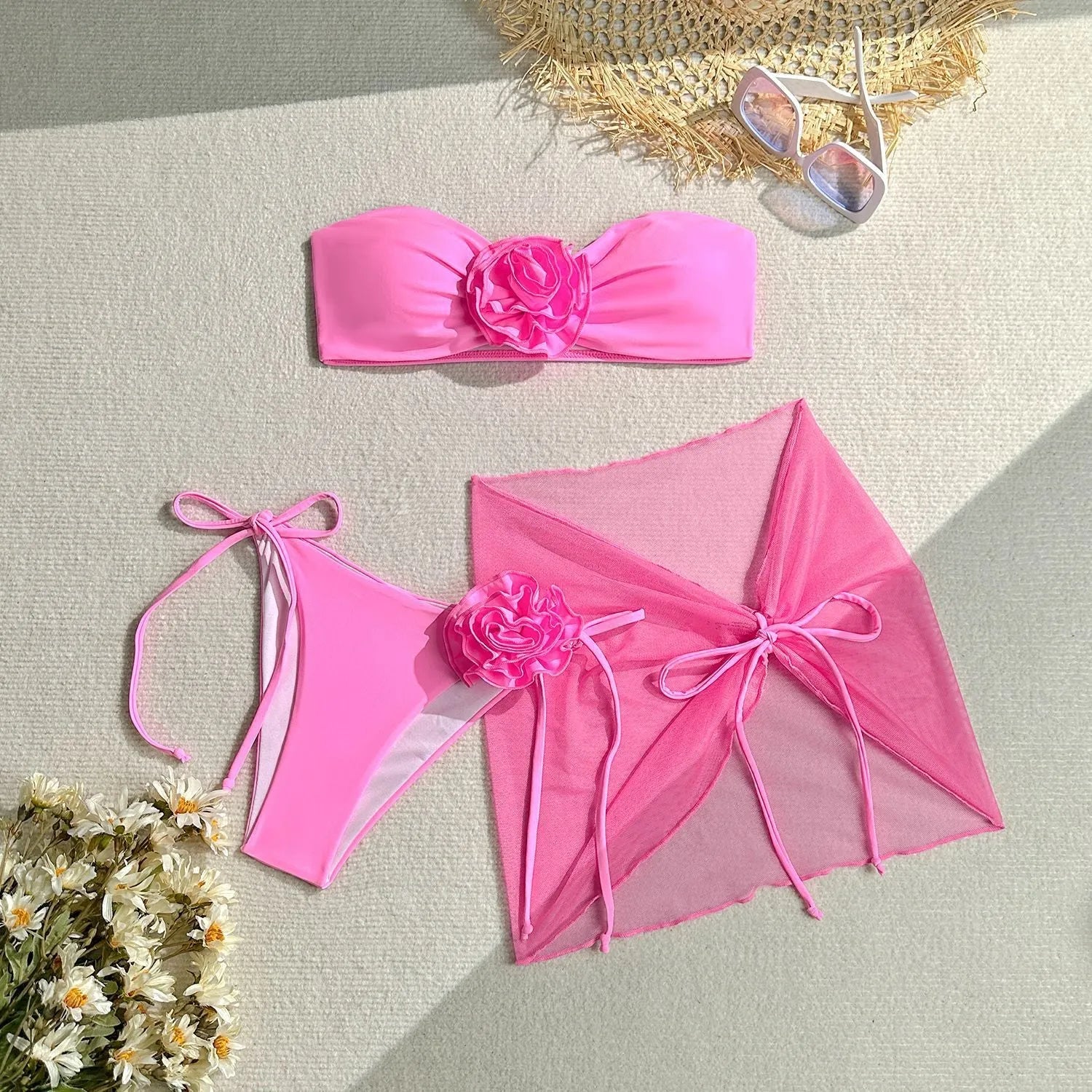 Blue women's tube top swimsuit with big 3D flower tie, matching bottoms, and skirt