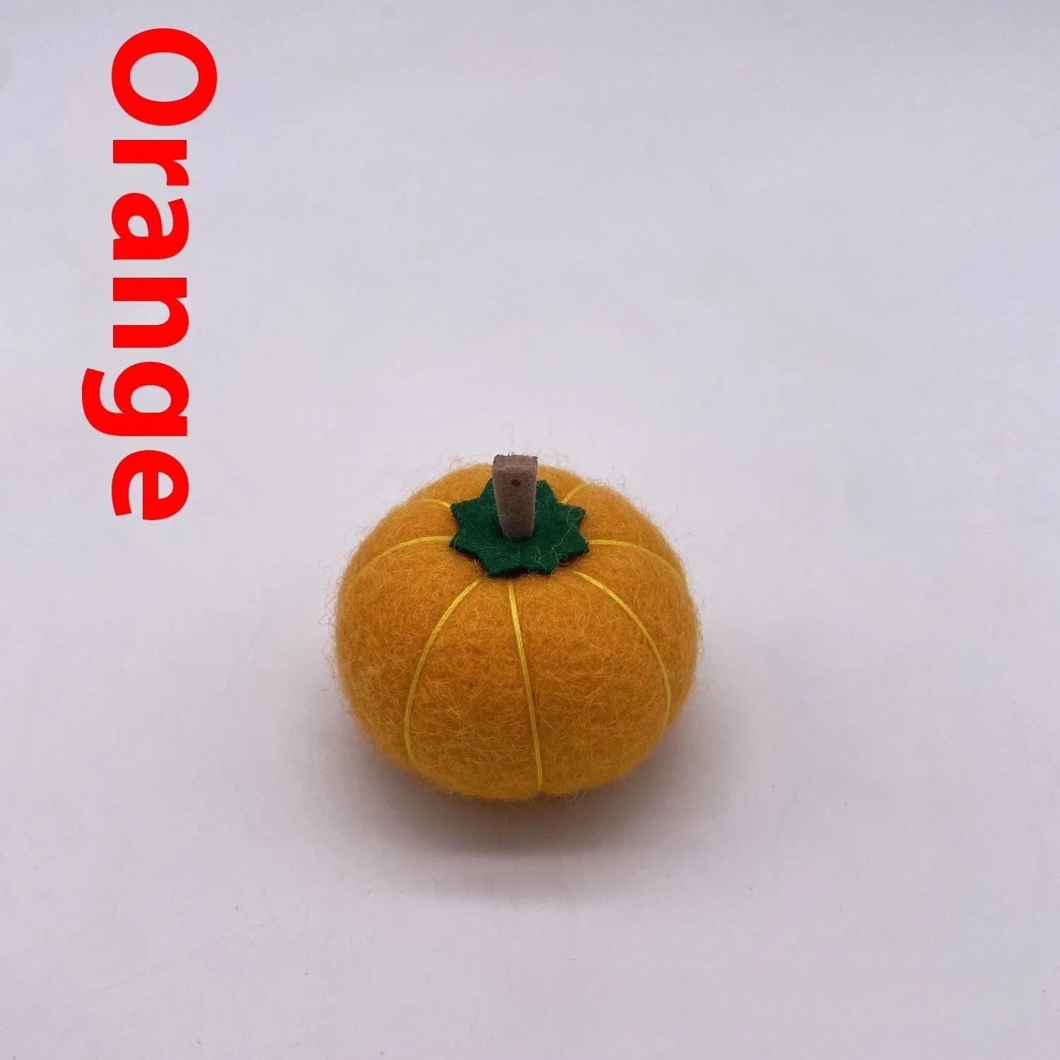 Wool felt pumpkin ornament in assorted colours for dollhouse decoration, approx. 5cm wide.