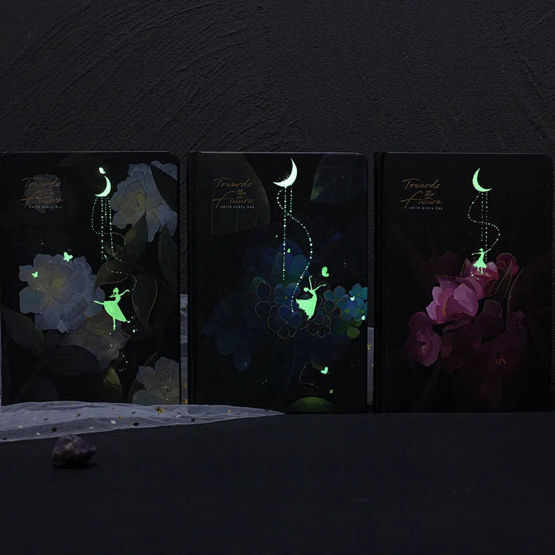 A5 size diary book with a luminous purple cover, open to show pages with colour illustrations.