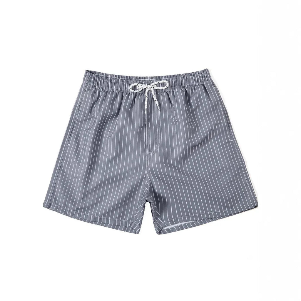 Navy blue and grey striped beach shorts with a straight leg opening on a mannequin.