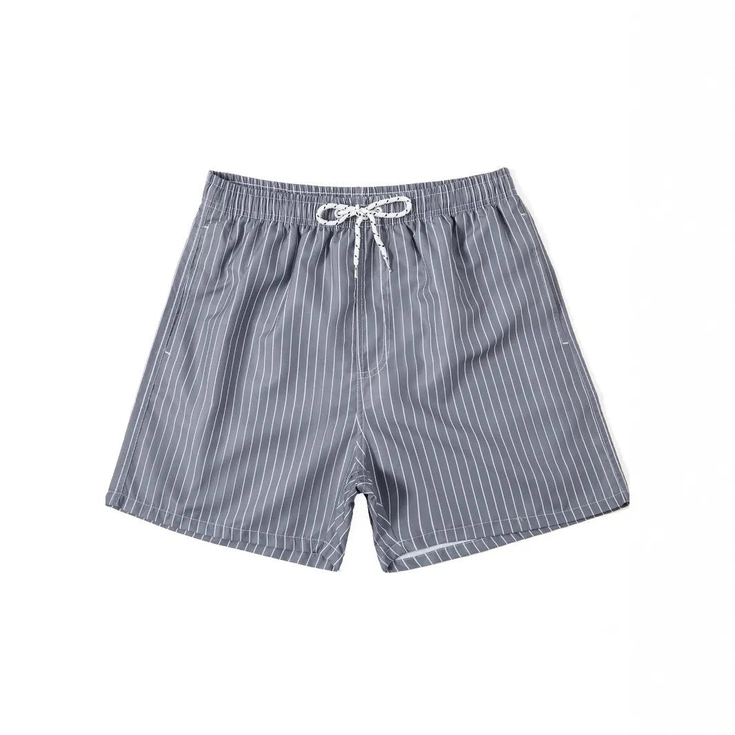 Navy blue and grey striped beach shorts with a straight leg opening on a mannequin.