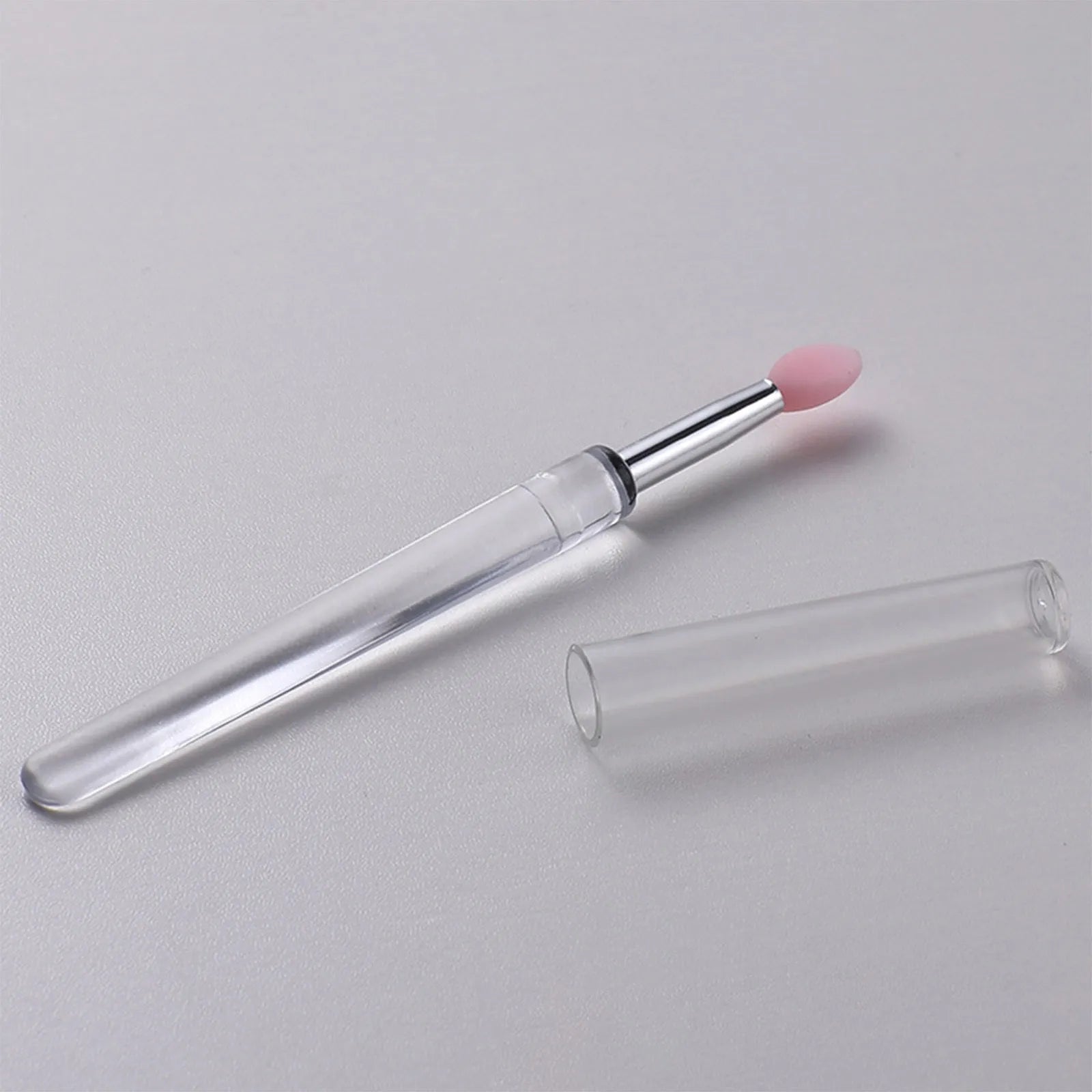 Set of reusable silicone lip brushes with protective caps in various colours.