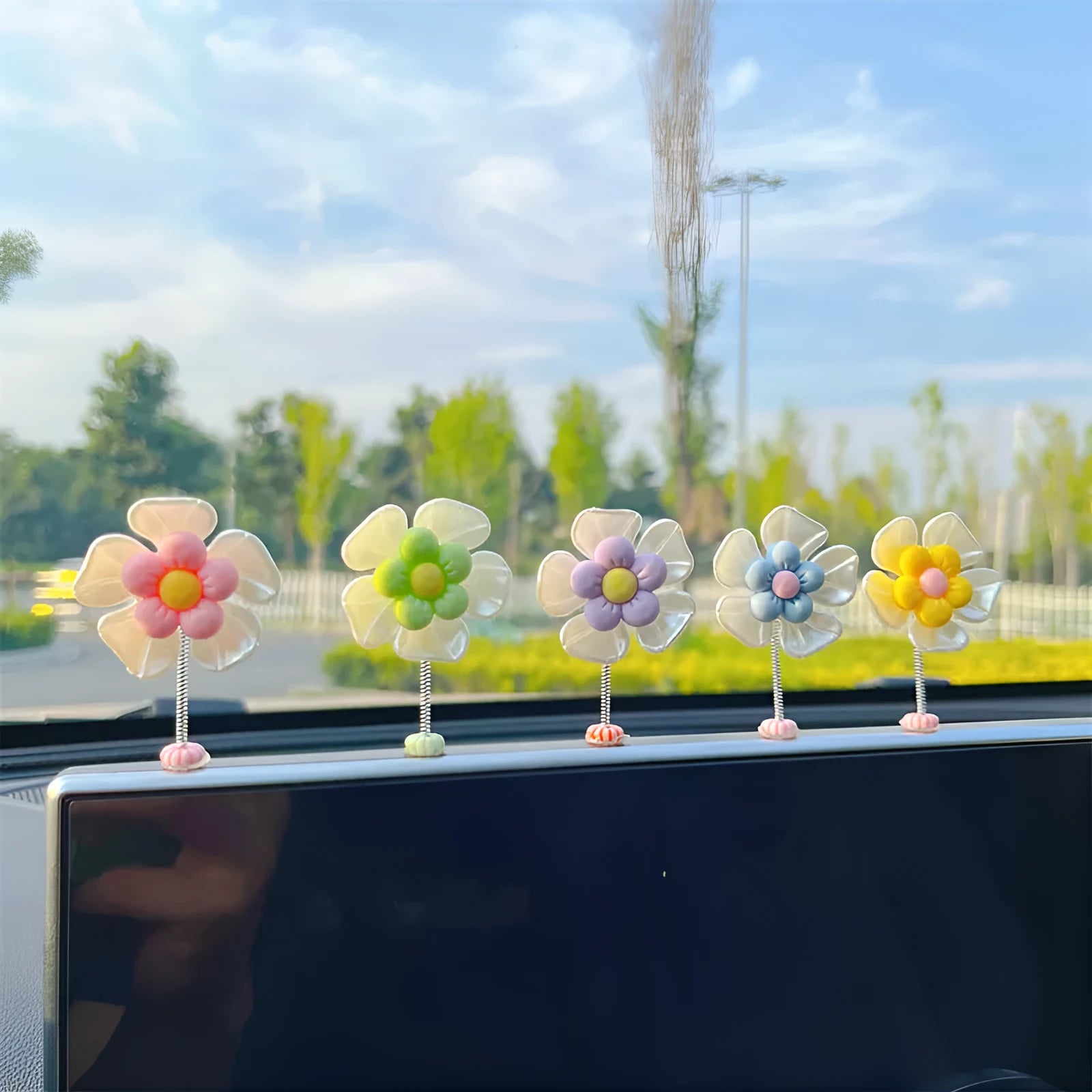 Small colourful plastic swing car decoration ornament in blue, green, pink, purple, or yellow.