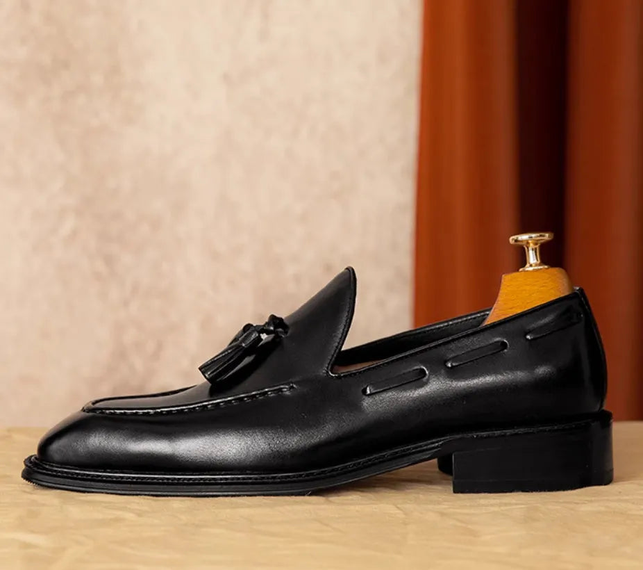Men's black and brown genuine leather slip-on loafers with a pigskin lining, shown in multiple sizes.