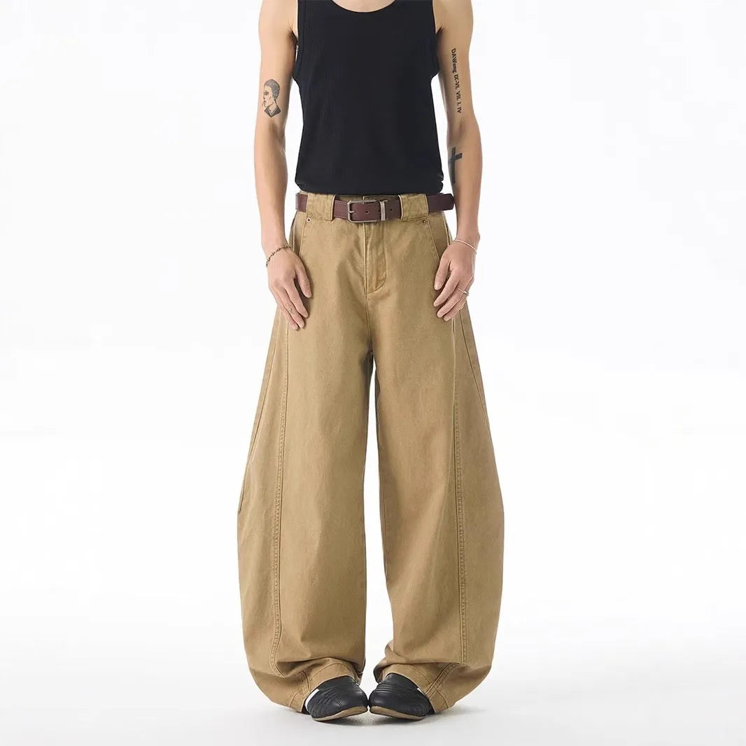 Men's brown loose-fit straight leg denim jeans on a plain background