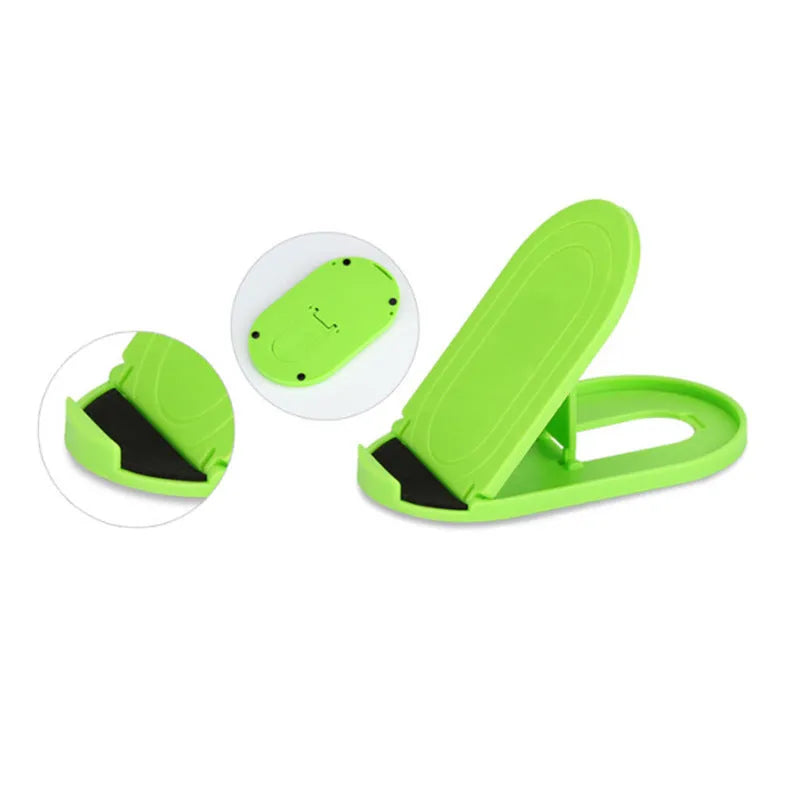Plastic lazy bracket mobile phone stand in six colour options on a desk.