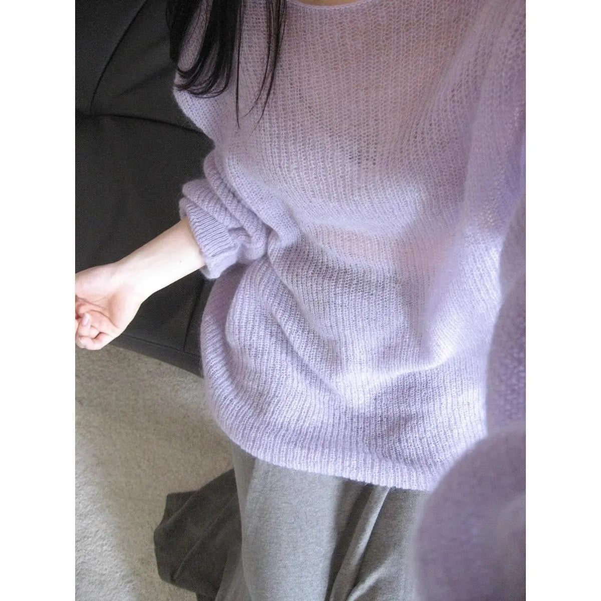 Purple lightweight women's blouse with hollow-out pattern and flared princess sleeves on a mannequin.