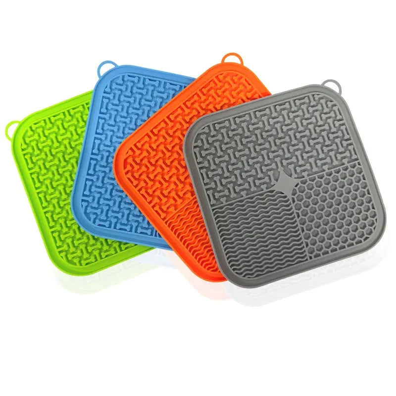 Square orange and grey silicone dog licking mat with textured surface and suction cups on back.