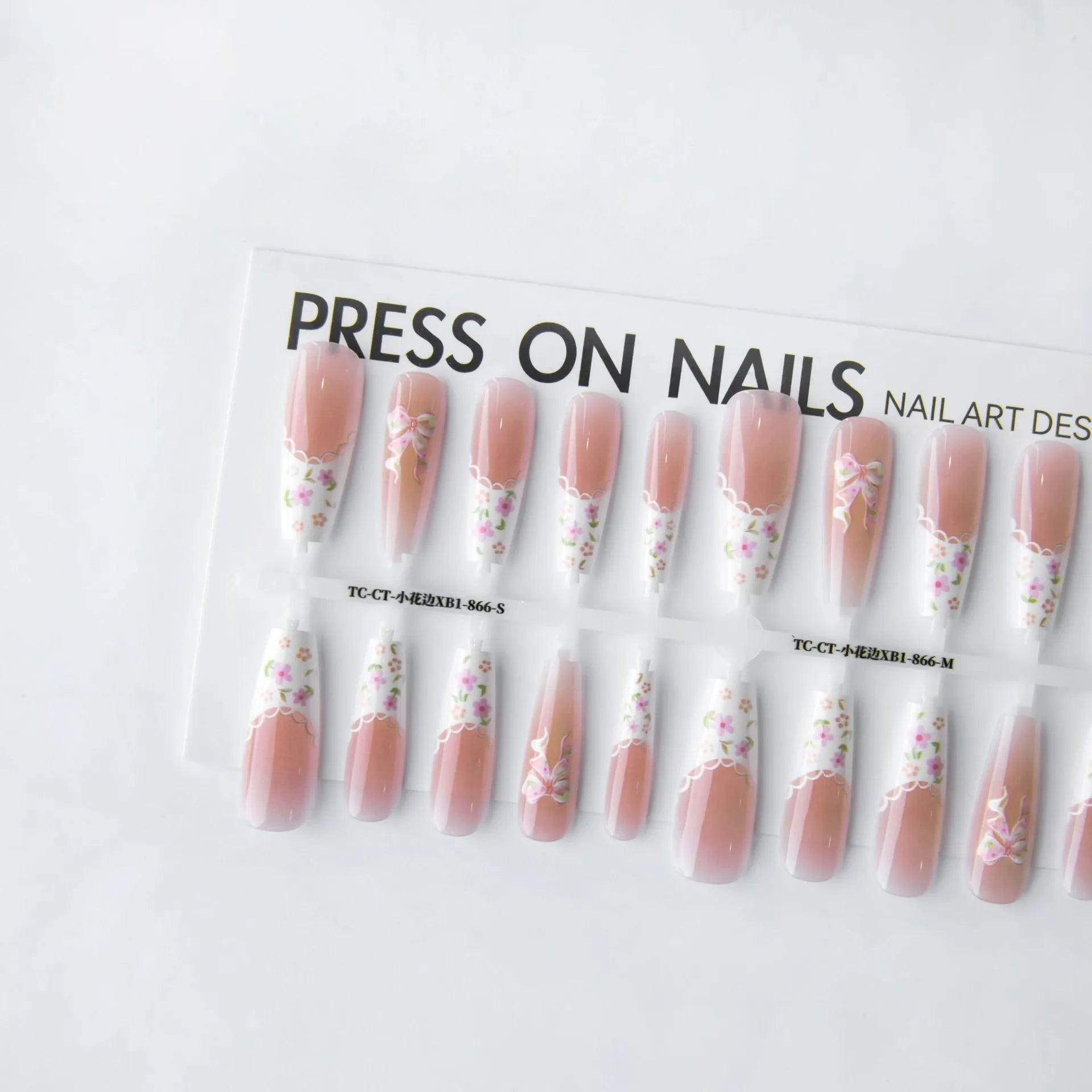 Set of 40 small floral prefabricated nail tips with long ladder velvet seal layer in white, displayed on a flat surface
