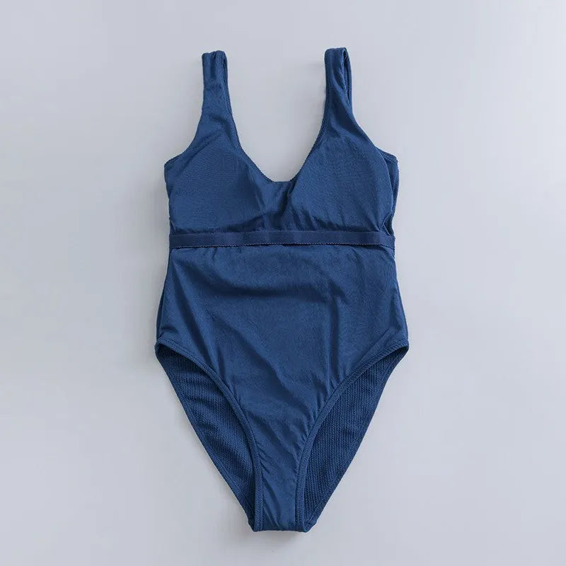 Navy blue women's one-piece swimsuit with slimming triangle silhouette and chest pads for swimming