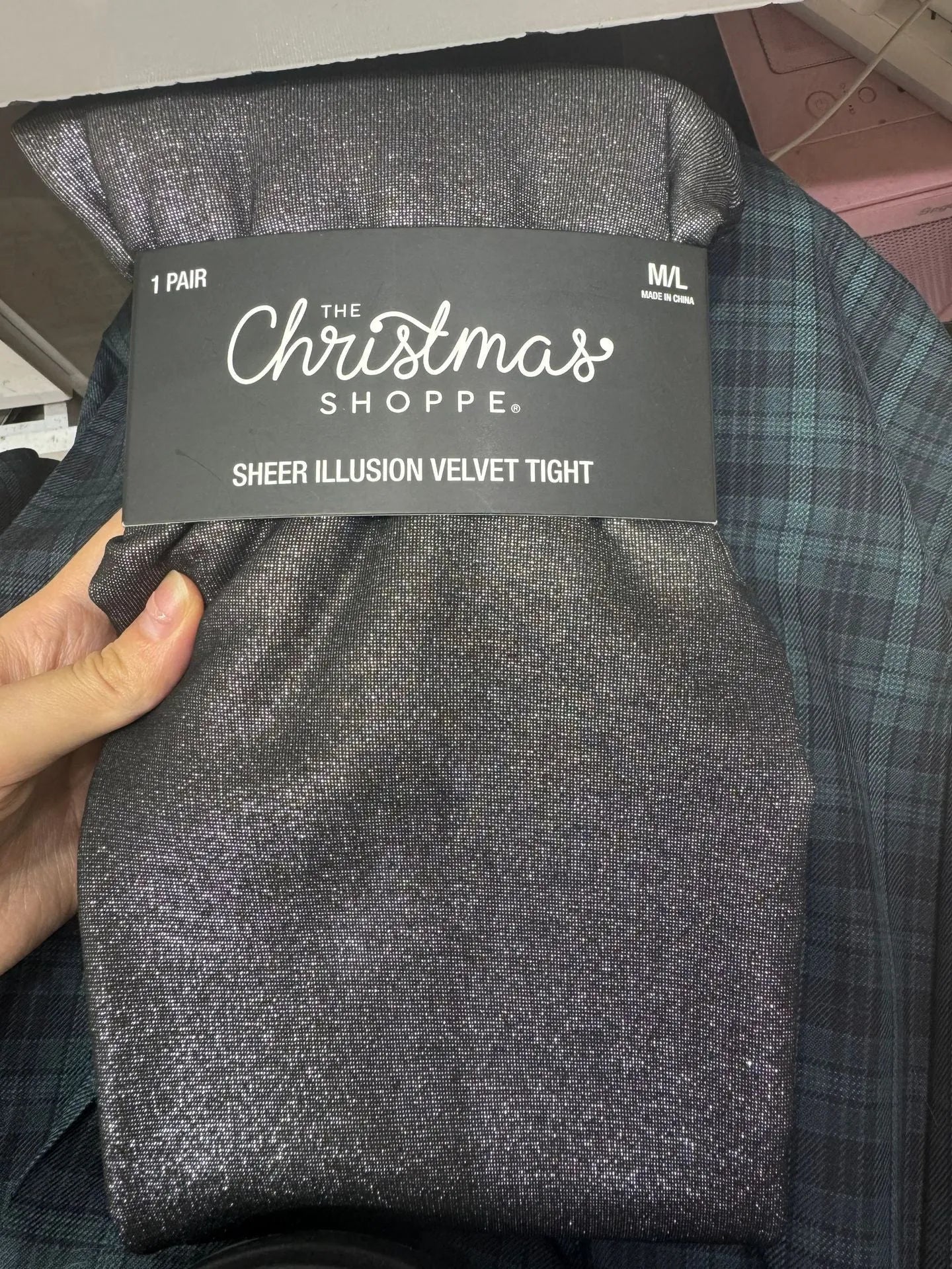 Women's black thermal leggings with a wool lining, shown in a flat lay.