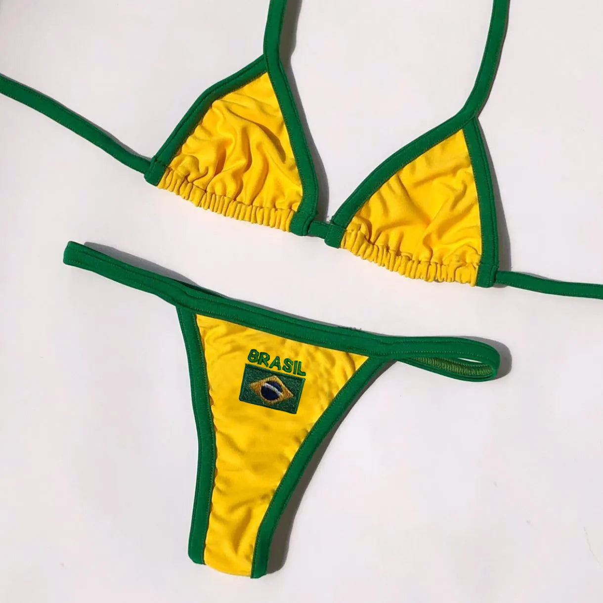 Yellow women's T-back bikini with sleeveless top and shorts-length bottoms on a mannequin