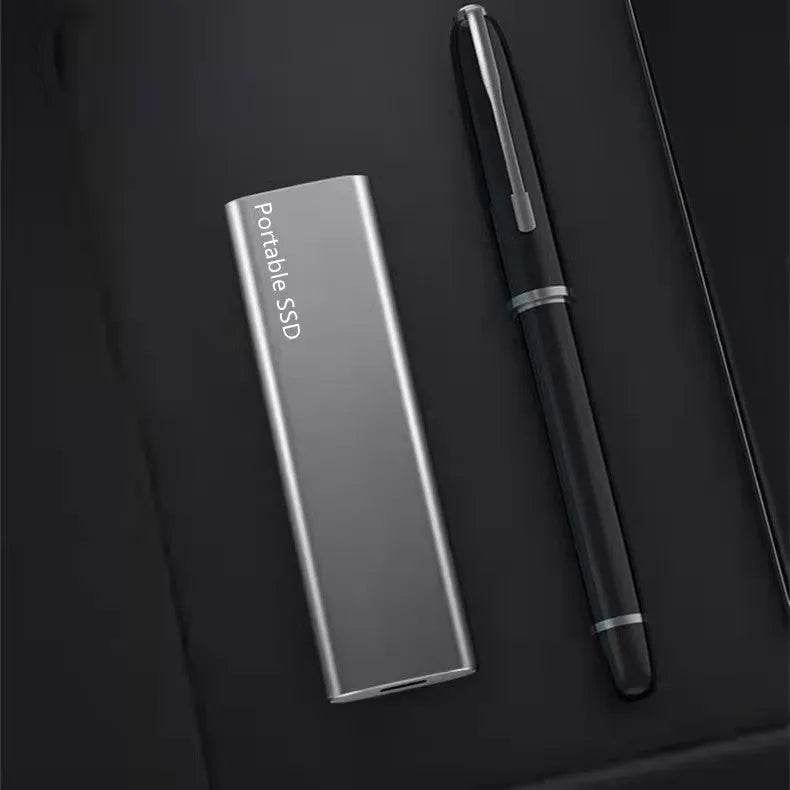 Metal-shell portable solid state drive with ultra-thin design on a desk.