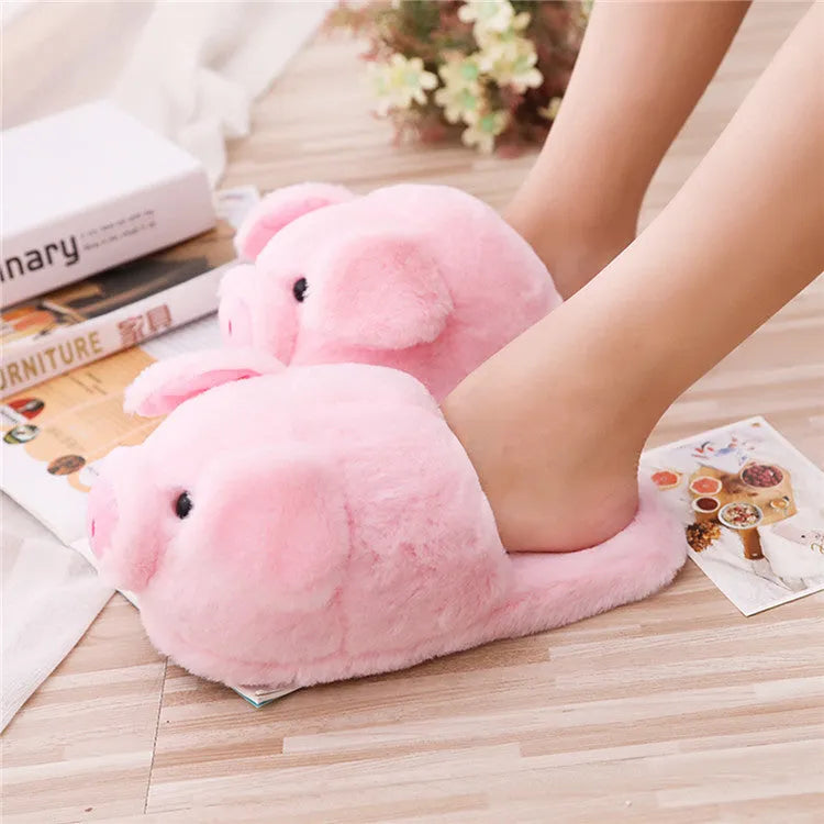 Pink pig design floor slippers with plush lining shown from side view