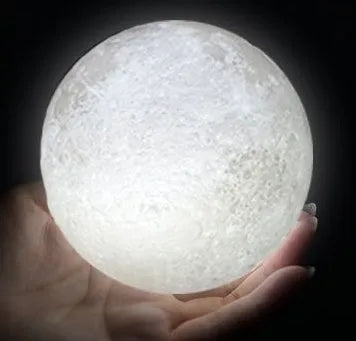3D printed white moon lamp on wooden stand with colour-changing LED light
