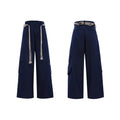 Men's dark blue straight-leg trousers showing heavy 3D cutting, belt stitching, and a front placket zipper.