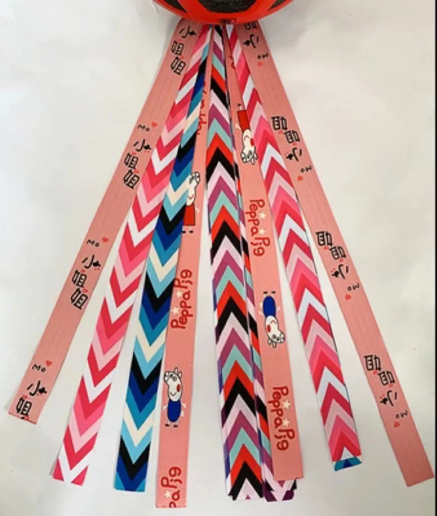 Close-up of a colourful decorative ribbon streamer attached to a child's helmet for roller skating or skiing.