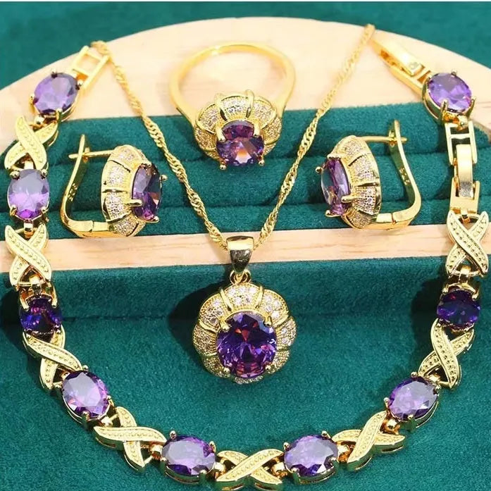 18k gold plated zircon jewellery set showing necklace, earrings, bracelet, and ring with sparkling cubic zirconia stones