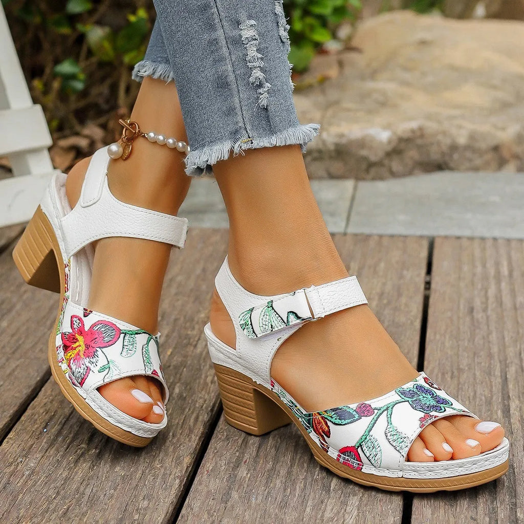 White women's high heel sandals with an adjustable velcro buckle strap on a rubber sole.