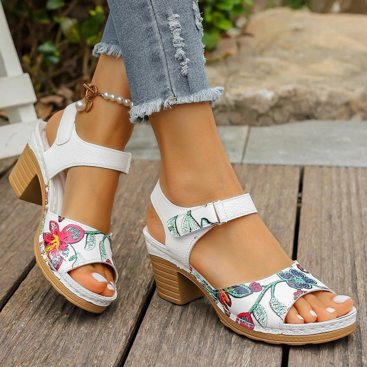 White women's high heel sandals with an adjustable velcro buckle strap on a rubber sole.