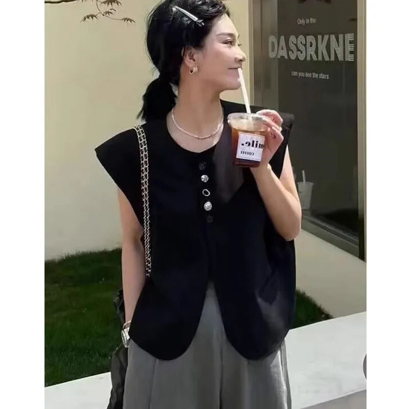 Women's loose-fit short-length polyester vest in milky white colour with front pockets.